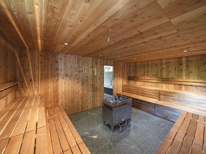 Our hiking and wellness hotel near Sterzing: Lahnerhof interior of a sauna with wooden walls and central stove
