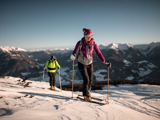 Lahnerhof: our hotel near Sterzing on Monte Cavallo/Rosskopf Two people ski touring on snow-covered mountains under clear sky