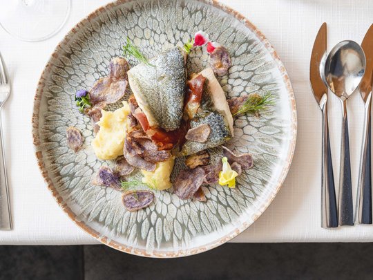 South Tyrolean specialities at our restaurant near Sterzing Fish fillet with mashed potatoes and chips on decorative plate