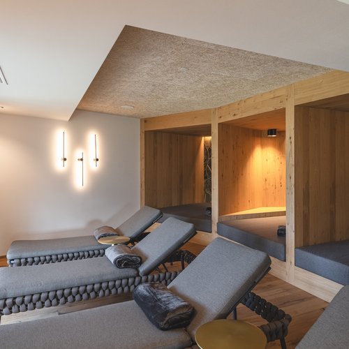 Hotel near Sterzing for wellness and sports Relax room with lounge chairs and illuminated wooden alcoves