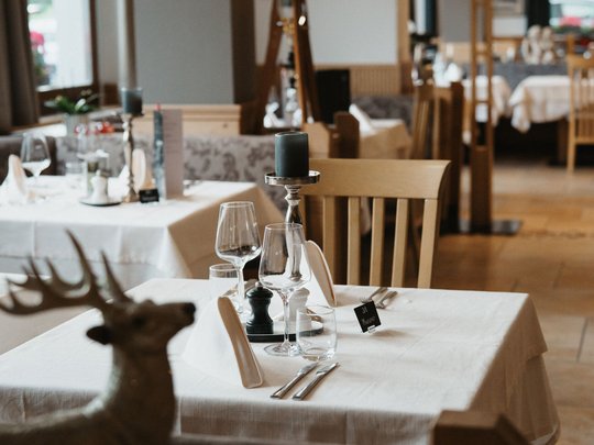 South Tyrolean specialities at our restaurant near Sterzing Elegant restaurant with set tables and wooden chairs
