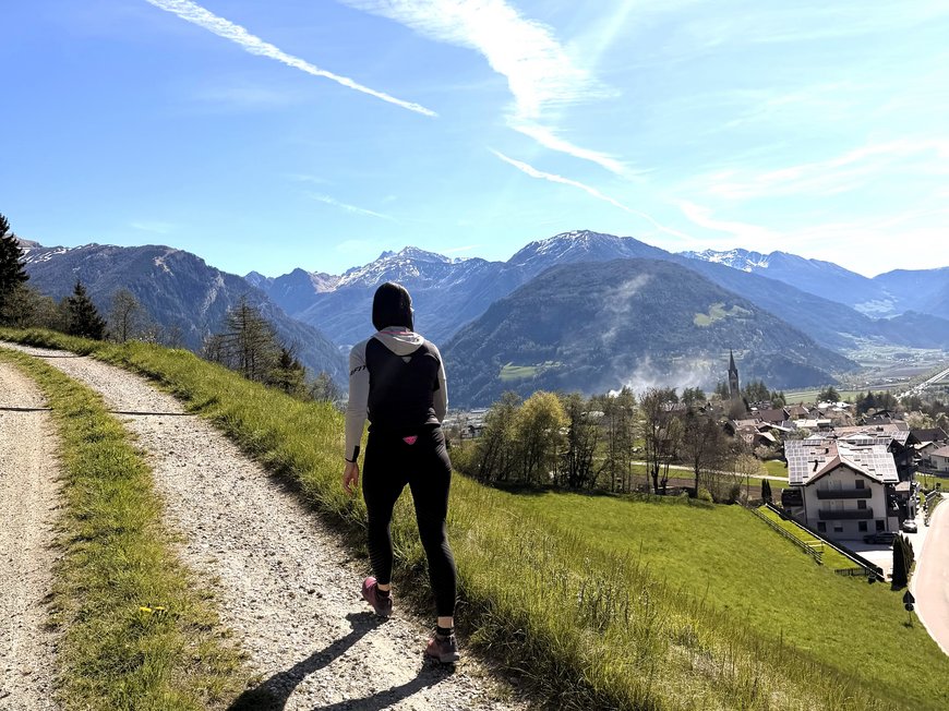 Our hiking and wellness hotel near Sterzing: Lahnerhof Hiker on path overlooking mountains and village in the valley
