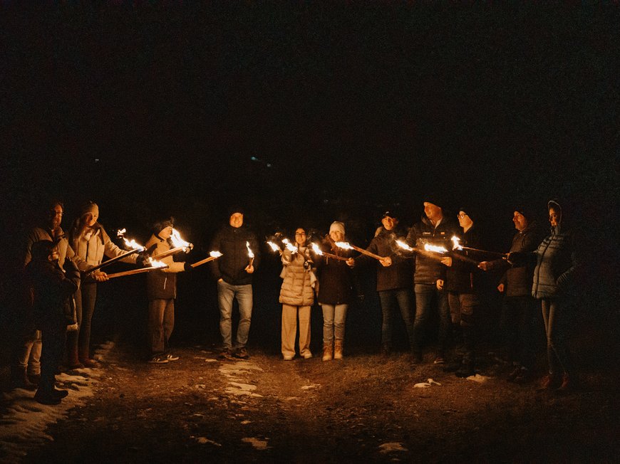 Our hiking and wellness hotel near Sterzing: Lahnerhof Group of people holding burning torches in the dark