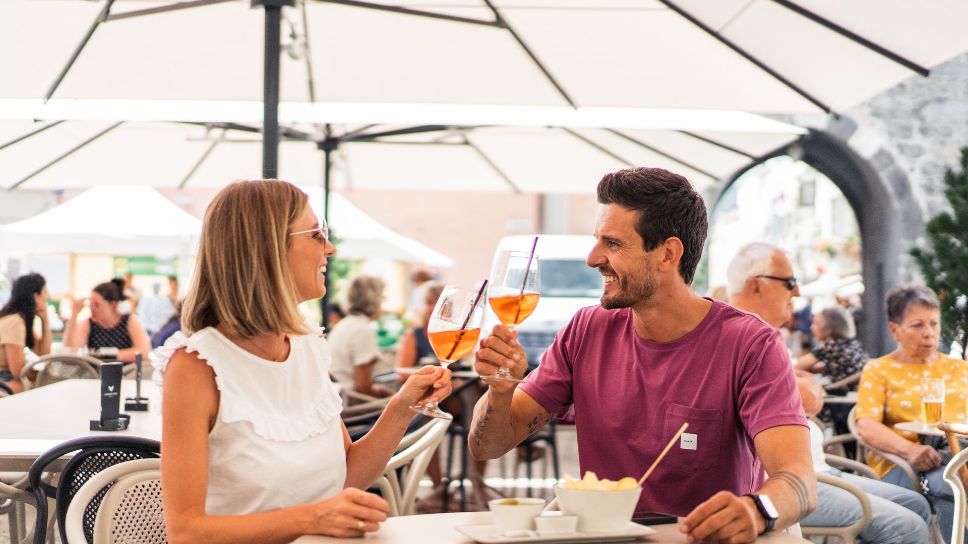 Hiking in Ratschings and surroundings Couple toasting drinks outdoors at a café
