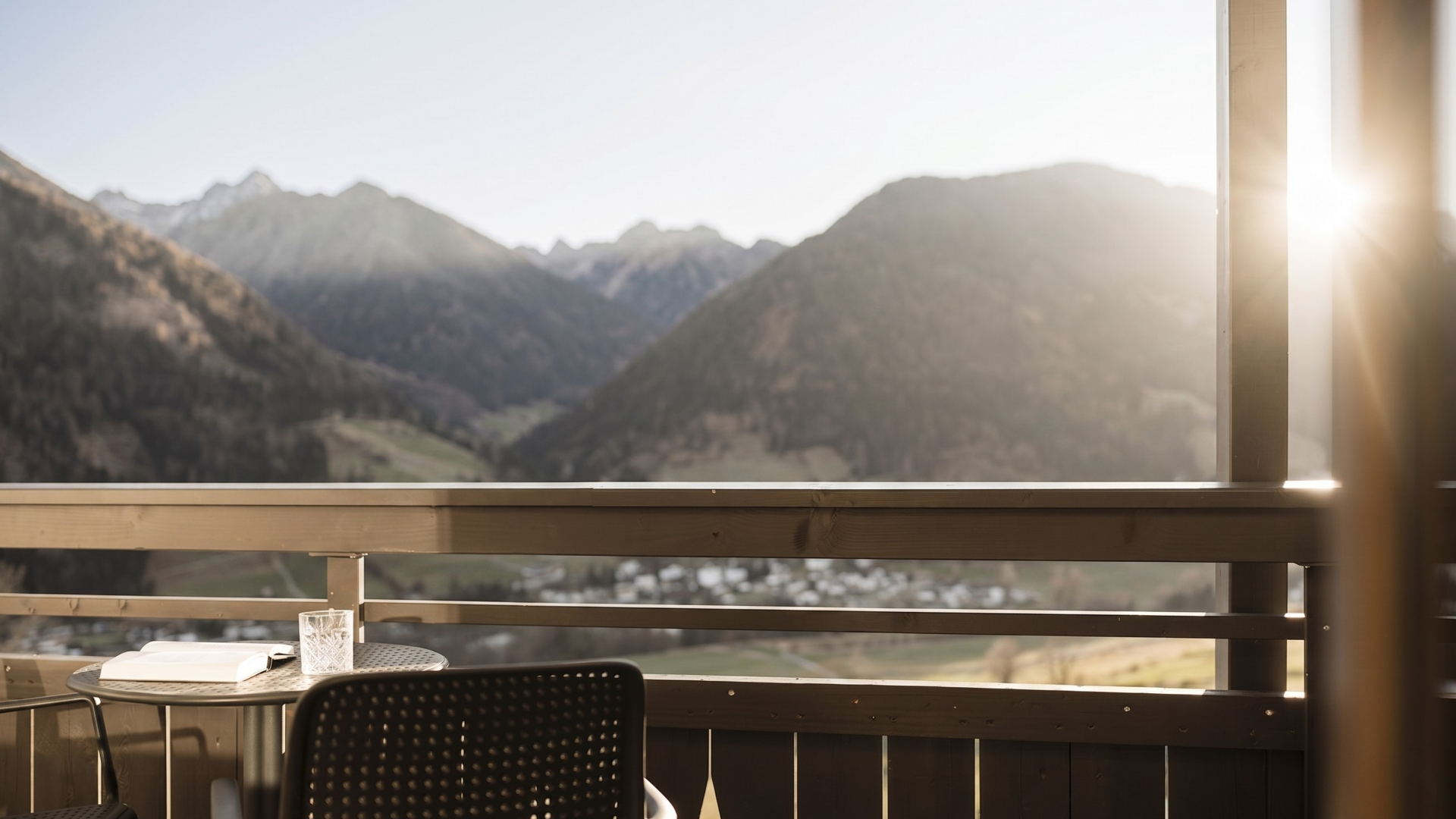 Lahnerhof, your hotel near Sterzing Balcony with table, chairs and mountain view in sunlight