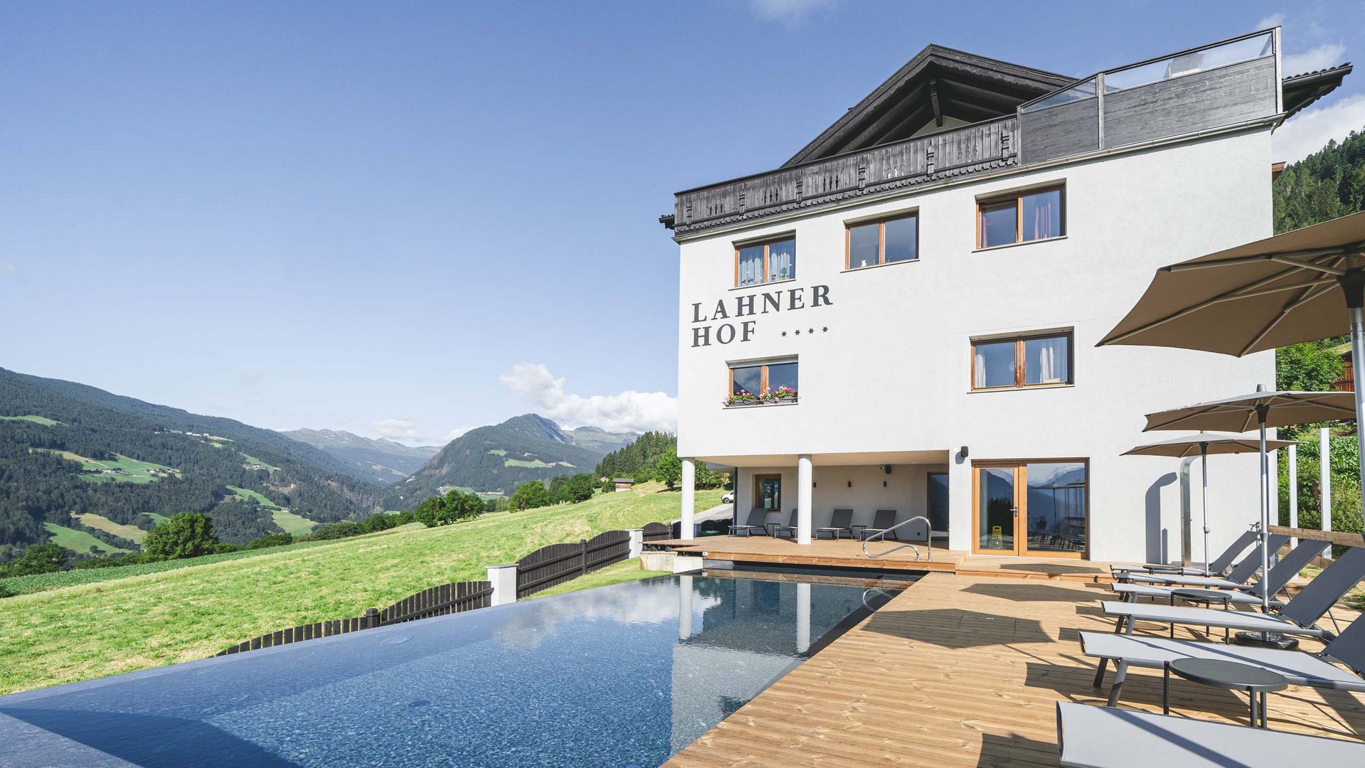 Lahrer Hof hotel with infinity pool and mountain view on a sunny day
